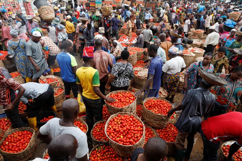 People buy and sell vegetables at Mile 12 International Market in Lagos