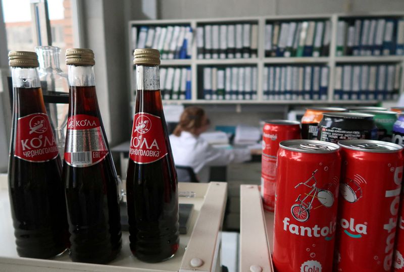 FILE PHOTO: A view shows bottles and cans of soft drinks at a plant of the Chernogolovka company in Moscow Region