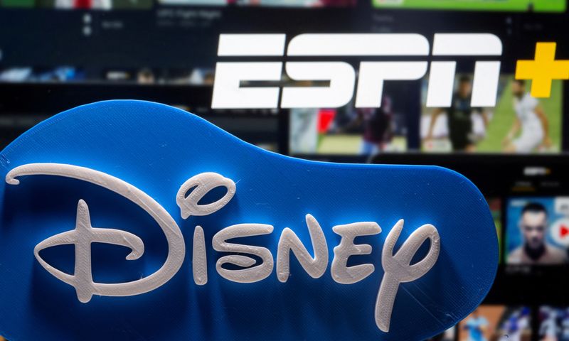 FILE PHOTO: Photo illustration of a 3D-printed Disney logo seen in front of the ESPN+ logo