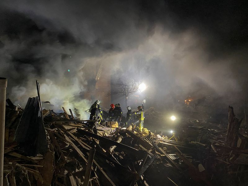 Rescuers work at the site of a residential building destroyed by a Russian missile strike in Kharkiv