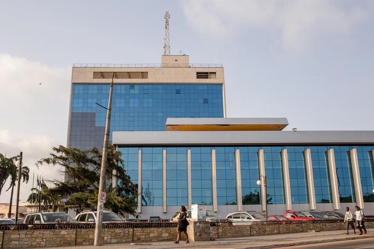 Pedestrians walk in front of Ghana's central bank building in Accra