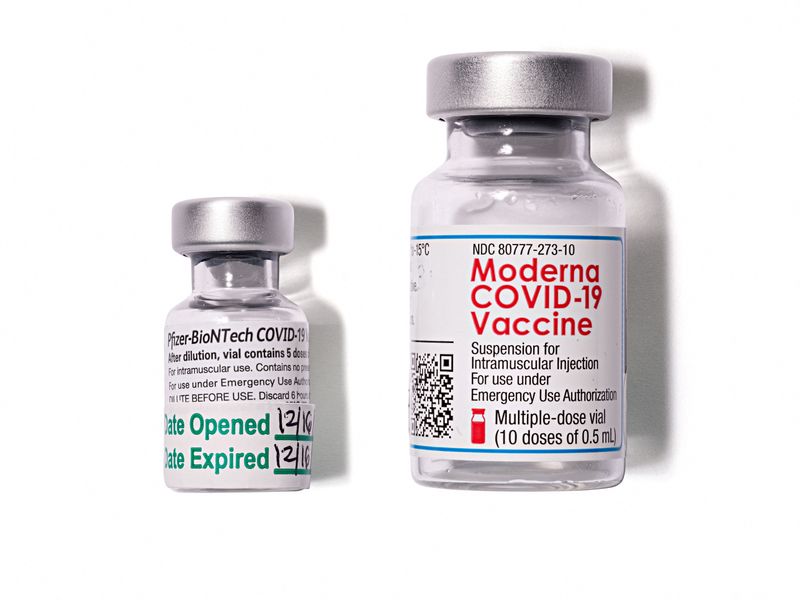 FILE PHOTO: Two empty glass vials of Pfizer Inc's Pfizer/BioNTech COVID-19 vaccine and Moderna's vaccine donated to the Smithsonian