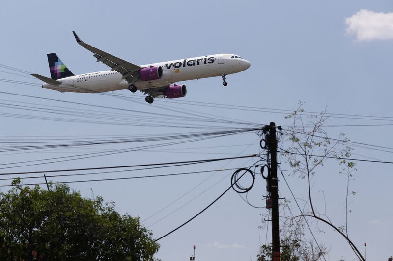 FILE PHOTO: A Volaris airplane prepares to land on the airstrip at Benito Juarez international airport in Mexico City