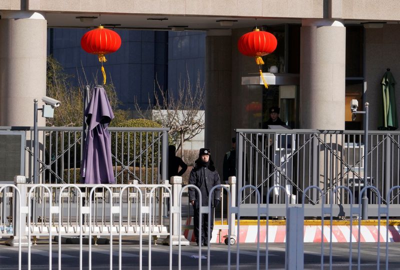 FILE PHOTO: Security personnel stand guard at headquarters of the Central Commission for Discipline Inspection of the Communist Party of China in Beijing