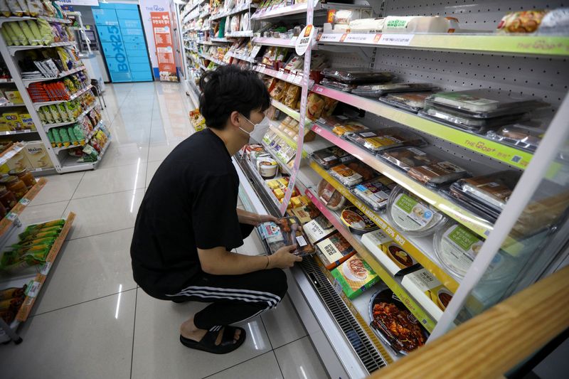 A customer picks up a lunch box at a convenience store in Seoul