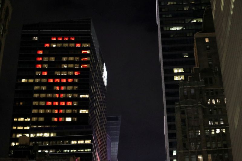 FILE PHOTO: The female gender symbol is seen displayed on the Ernst and Young Building on International Women's Day in Times Square in New York City, New York