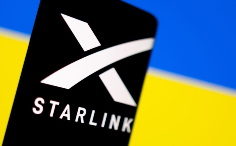 FILE PHOTO: Illustration shows Starlink logo and Ukraine flag
