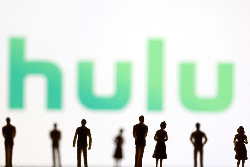 FILE PHOTO: Toy figures of people are seen in front of the displayed Hulu logo, in this illustration