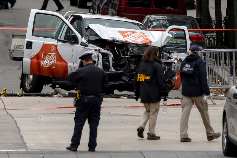 FILE PHOTO: FBI agents and NYPD investigate a pickup truck used in an attack on the West Side Highway in lower Manhattan in New York