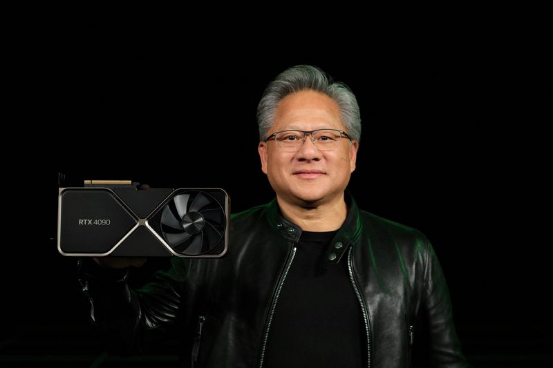 Nvidia Corp CEO Jensen Huang holds one of the company's new RTX 4090 chips for computer gaming in this undated handout photo
