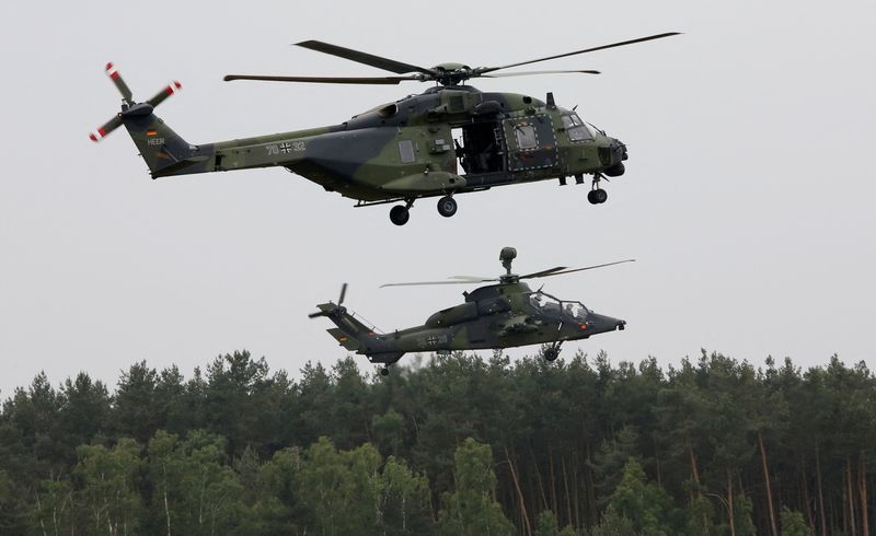 FILE PHOTO: A German Bundeswehr armed forces NH 90 helicopter and a Tiger attack helicopter are seen during a drill at Holzdorf Air Base