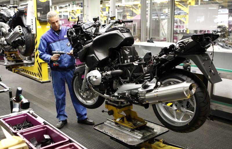 FILE PHOTO: A BMW employee assembles a BMW motorcycle at the company's factory in Berlin