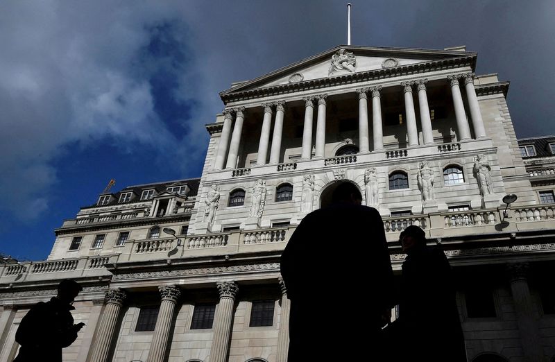 FILE PHOTO: City workers walk past the Bank of England in the City of London, Britain