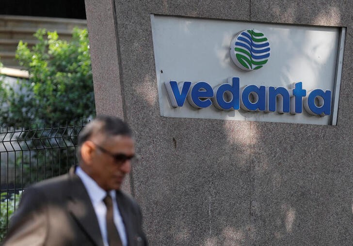 FILE PHOTO: A man walks past the logo of Vedanta outside its headquarters in Mumbai