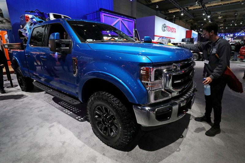 FILE PHOTO: A worker polishes a Ford Super Duty F350 4X4 truck at the Canadian International Auto Show in Toronto