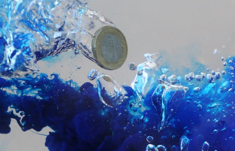UK pound coin plunges into water in this illustration picture