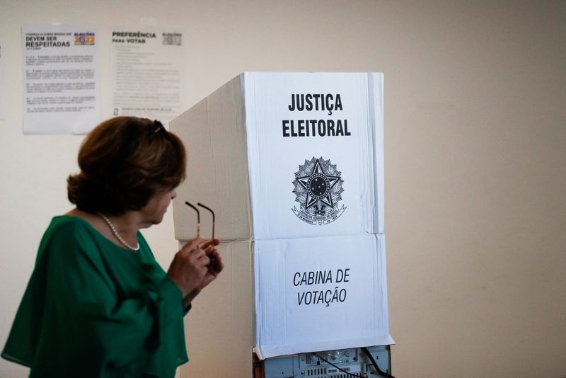 A Brazil citizen passes by a voting booth for Brazil's election, in Lisbon