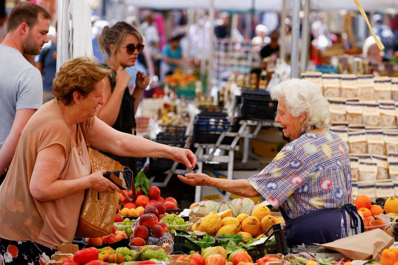 FILE PHOTO: A woman shops at Campo de' Fiori market in Rome