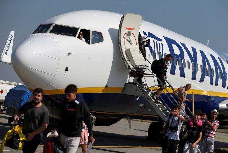 FILE PHOTO: Passengers alight from a Ryanair aircraft at Ferenc Liszt International Airport in Budapest
