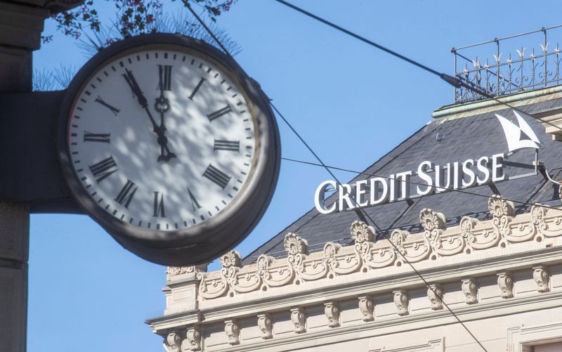 FILE PHOTO: A clock is seen near the logo of Swiss bank Credit Suisse in Zurich