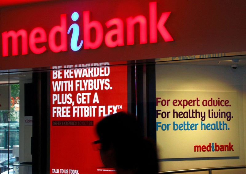 FILE PHOTO: A woman walks past a branch of the Australian health insurer Medibank Private in Sydne