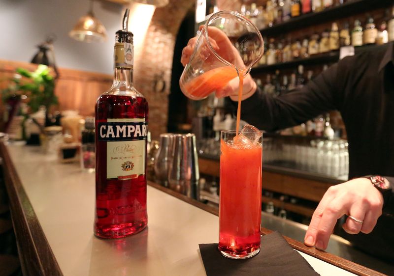 FILE PHOTO: A barman prepare a Campari orange  cocktail in a Milan bar