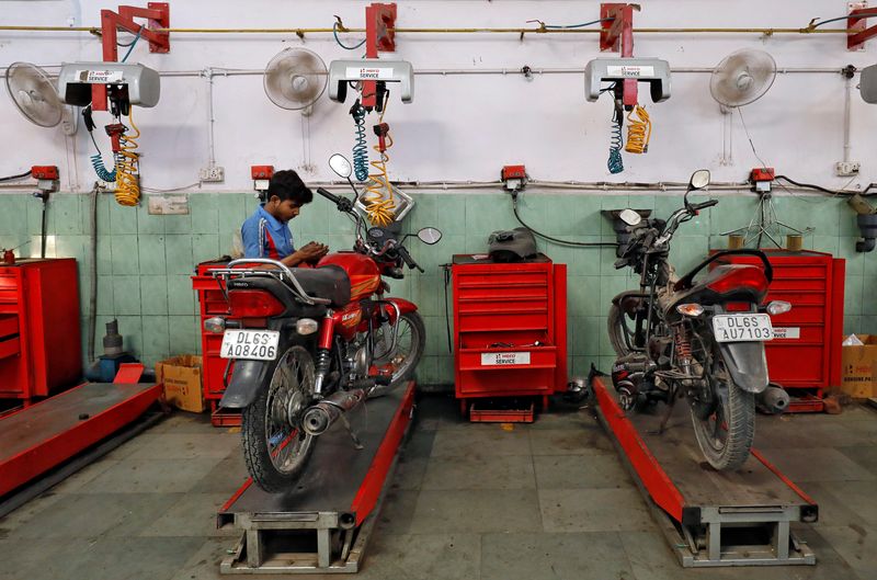 FILE PHOTO: An employee works on a motorbike inside a Hero MotoCorp service station in New Delhi