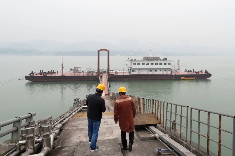 Staff members of China Gas Holdings are seen at an LNG refueling station for ships in Chongqing