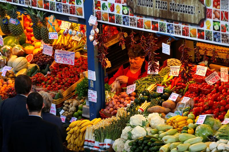 A vendor packs vegetables at the Grand Market hall in Budapest