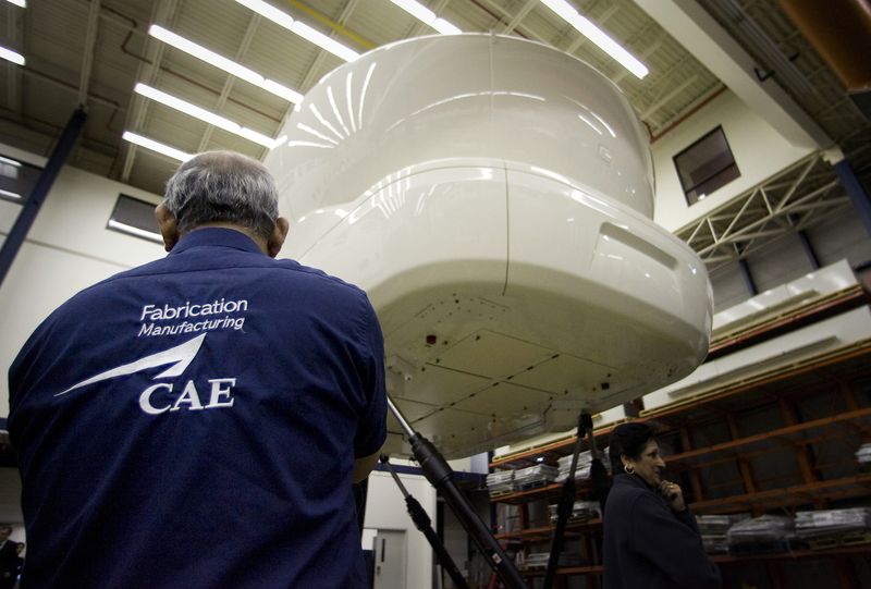 FILE PHOTO: An employee looks up at a CAE 7000 Series simulator at CAE Inc. headquarters in Montreal