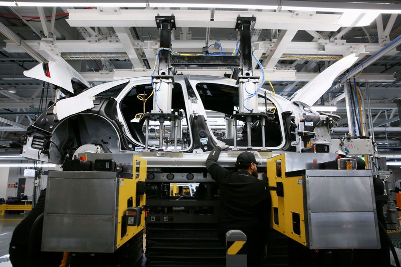 FILE PHOTO: Workers assemble electric vehicles at the Lucid Motors plant in Casa Grande