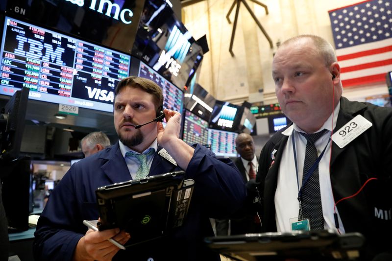 Traders work on the floor of the New York Stock Exchange near the closing bell of the trading session in New York City