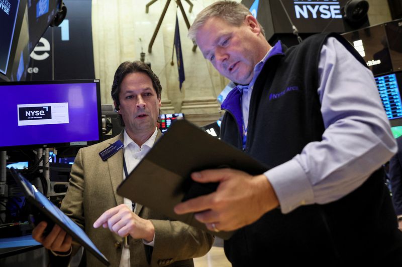 FILE PHOTO: Traders work on the floor of the NYSE in New York City