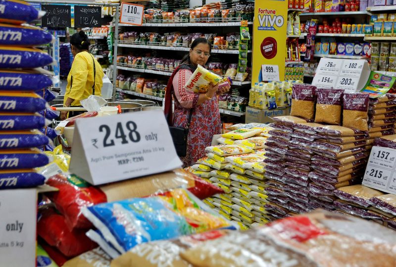 A woman looks at an item as she shops at a food superstore in Ahmedabad