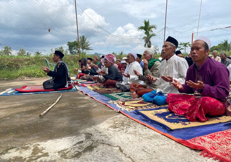 Friday prayers at a volleyball field after the Monday's earthquake in Cianjur