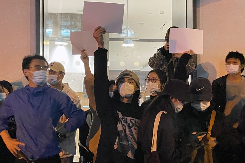 People hold paper sheets in Shanghai