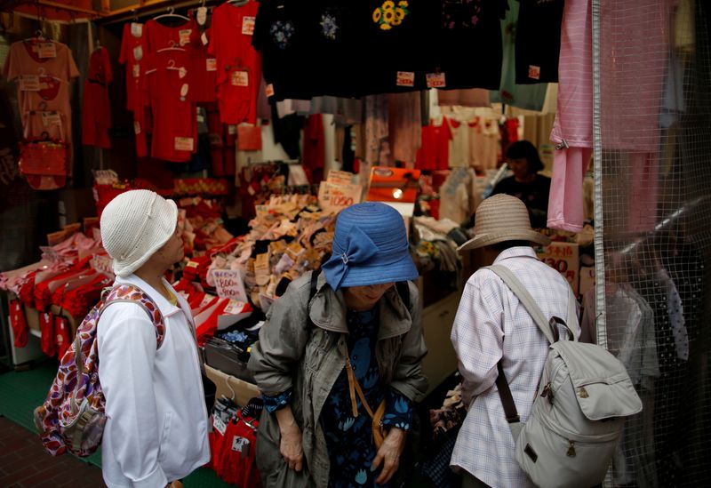 Women check items at a retail shop at Tokyo's Sugamo district