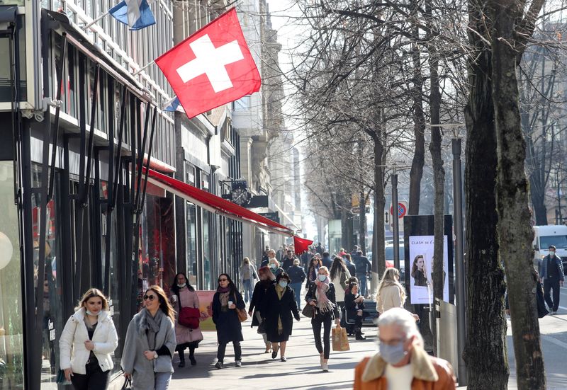 FILE PHOTO: Shoppers walk along the street after the Swiss government relaxed some of its COVID-19 restrictions in Zurich