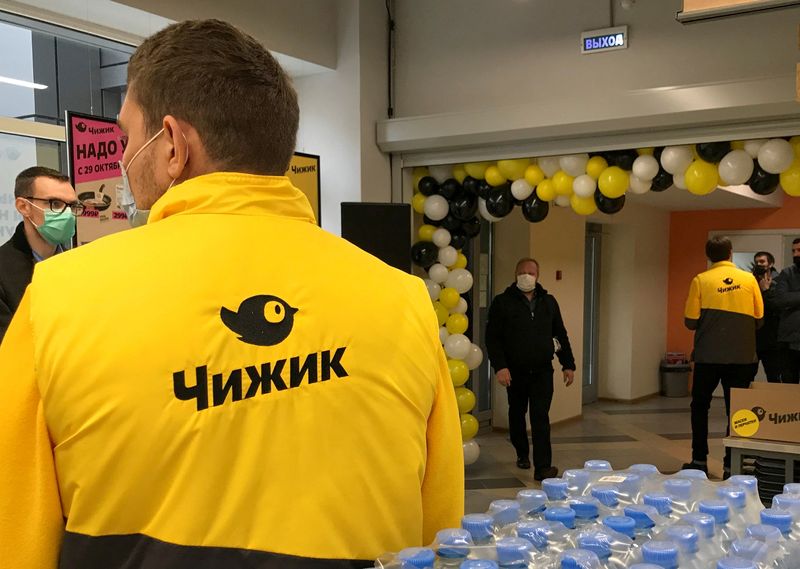 FILE PHOTO: Employees attend a ceremony to launch the discount shop Chizhik in Moscow