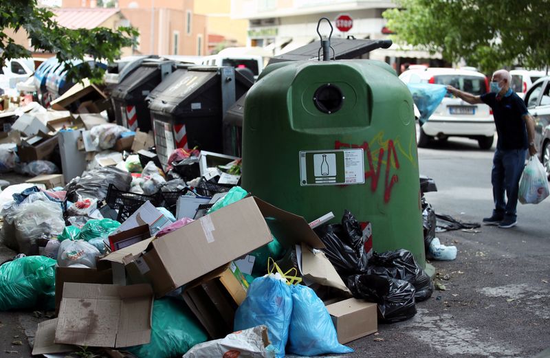 FILE PHOTO: Rubbish mounts up around garbage containers as Rome authorities struggle to provide a regular disposal service