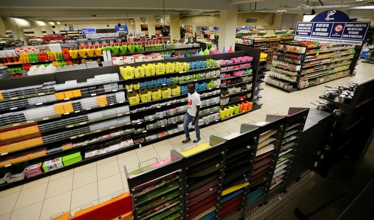 A shopper walks past products displayed on the shelves inside the Nakumatt supermarket within the Village market complex mall, in Nairobi