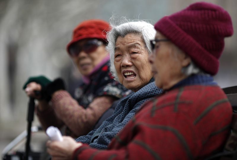 FILE PHOTO: Elderly women sit at a park in downtown Shanghai