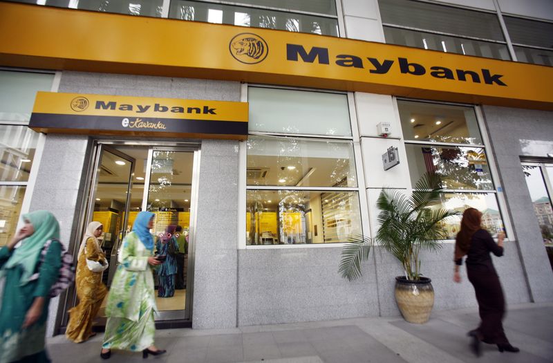 FILE PHOTO: Customers leave a branch of Malaysia's Maybank in Putrajaya