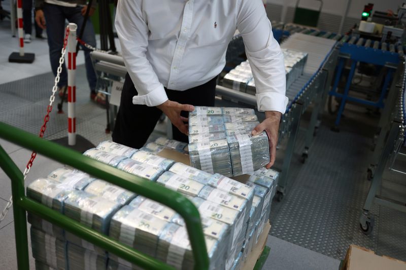 FILE PHOTO: A worker grabs a pack of 20-euro notes at the Bank of Portugal fortified complex in Carregado, Alenquer