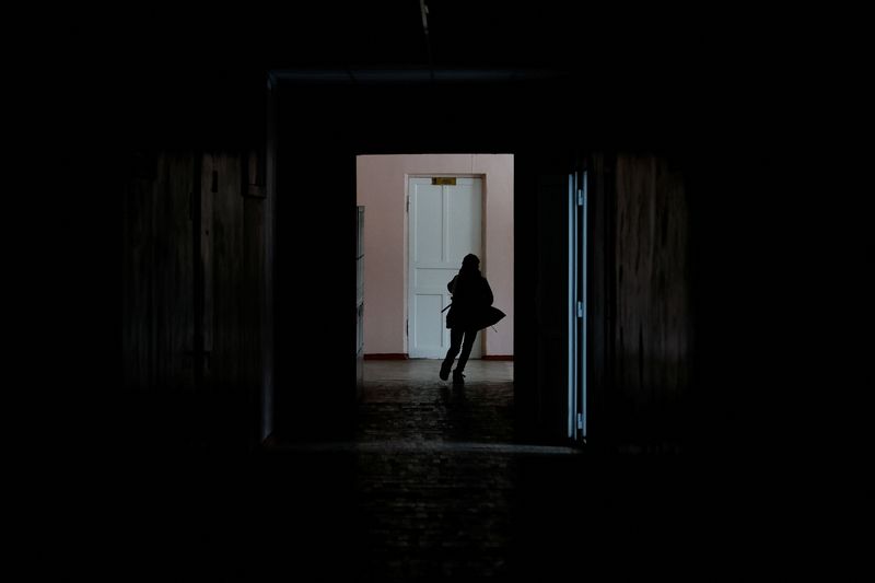 Junior student runs along a corridor inside a school in Kyiv