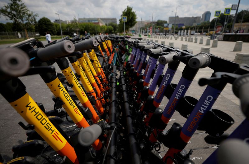 FILE PHOTO: Electric scooters are parked at a station in Moscow