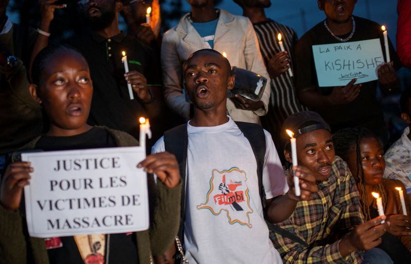 Congolese activists attend a vigil in memory of the civilians killed in the recent conflict between FARDC and rebel forces, in Goma