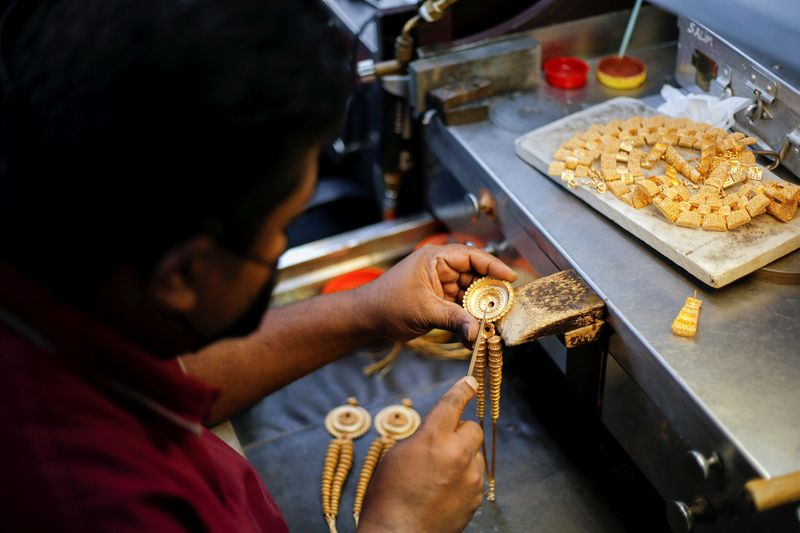 FILE PHOTO: Jewellery artisans manufacture gold jewellery at Devji, a major manufacturer and retailer, in Hidd