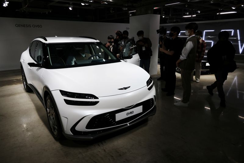 FILE PHOTO: Members of the media take photographs of a Genesis GV60 electric vehicle during its showcase in Seoul