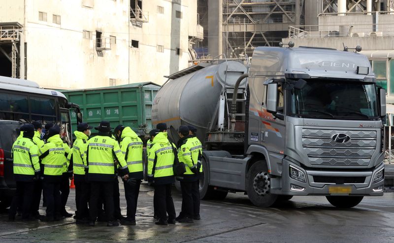 Policemen are deployed at a cement factory as unionized truckers go on a strike in Danyang